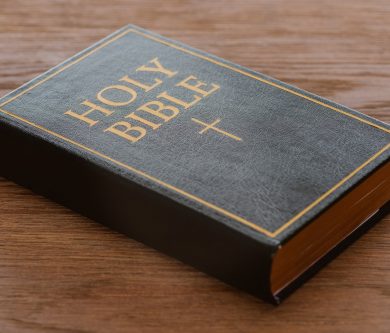 close-up shot of holy bible lying on wooden surface